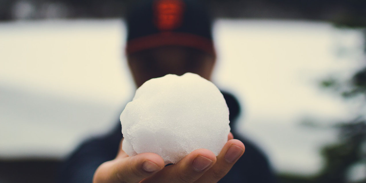 man holding snowball